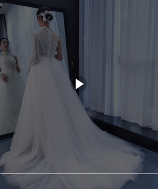 Vestido de novia con sobrefalda de cuentas de perlas y escote alto y manga de un solo hombro